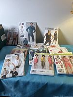 Front view of assorted packaged sewing patterns displayed on table