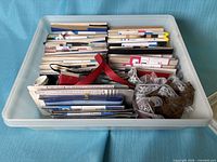 Top view of plastic bin filled with packaged sewing trims