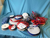 Group of assorted Velcro tape spools and loose strip on blue cloth