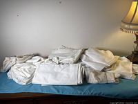 Multiple folded white fabrics on dresser