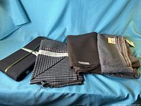 Four folded fabric pieces laid out on blue background