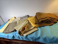 All seven fabric cuts laid out on blue surface