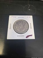 Reverse of the 1942 Canadian 50 cent coin in cardboard holder