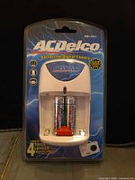 Front of sealed ACDelco charger package with two AA batteries visible