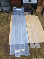 Long blue-film and clear acrylic strips laid on plywood