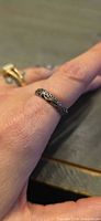 Ring on finger showing filigree design and overall appearance