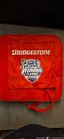 Front view showing Bridgestone logo on pocket and carry handle