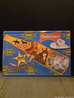 Front of rectangular Budweiser tin sign with western graphics