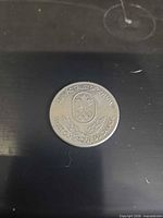 Obverse of coin showing maple leaf shield and Olympic rings