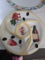 Top view showing painted wine, grapes, baguette, olives, and compartment layout