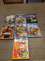 Seven Disney Blu-ray movie cases laid out on table