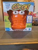 Front of sealed Gator Golf box showing orange gator figure through window