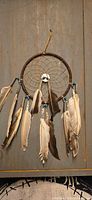 Full view of dreamcatcher showing hoop, web, beads, feathers