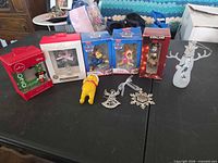 Group shot of all nine ornaments including boxed items and loose pieces on table