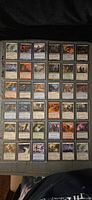 Full view of binder page containing 36 Magic: The Gathering cards