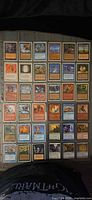 Binder page containing 36 sleeved Magic: The Gathering cards, assorted colors