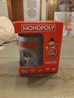 Front of boxed Monopoly mug showing logo and dog token