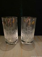 pair of glass tumblers with etched crests