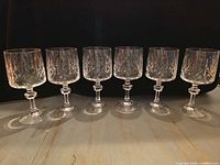 All six crystal wine glasses lined up to show full set
