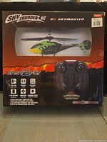 Front of sealed box showing helicopter, controller image, branding and features