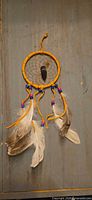 Front view of the entire dreamcatcher displaying hoop, web, beads, feathers