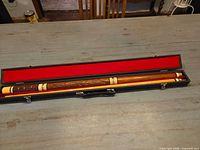 Cue assembled in open red-lined case