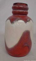 Front view of red and cream ceramic vase