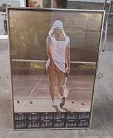 Full view of framed calendar poster standing upright