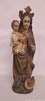 Front view of carved wood Madonna and Child statue showing overall form and paint loss