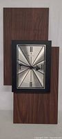 Full view of Bulova wall clock showing layered wood panels and metal face