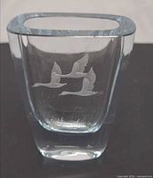 Front view showing etched flying birds and grass motif on vase