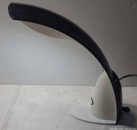 Side view of OttLite desk lamp showing arc design and power cord