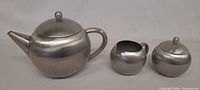 side view of teapot, creamer, sugar bowl