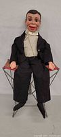 Full view of dummy seated on folding stool