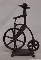 Side view of full cast iron penny-farthing bicyclist sculpture