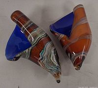 Top view of both conch shell glass sculptures showing multicolour exteriors