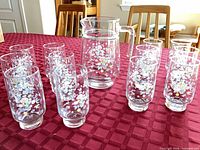 Full set showing pitcher and twelve tumblers on table