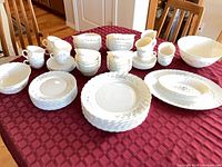 Entire dinnerware set arranged on table showing quantity and variety