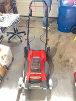 Front and side view of Craftsman cordless mower showing handle and body