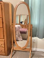 Front view of oval cheval mirror showing full frame and stand