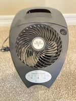 Front view of tabletop evaporative humidifier showing fan grill, control panel, handle, and power cord