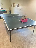 Overall view of foldable table tennis table, net, legs and playing surface