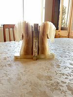 Front view of both onyx horse head bookends holding a book