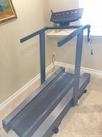 Full view of treadmill showing frame, running deck and console