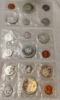 Three sealed proof-like coin sets in plastic pouches
