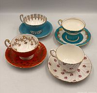 Group shot showing all four Aynsley teacup and saucer sets with pattern details visible