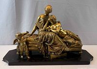 Front view of entire gilded bronze sculpture on base