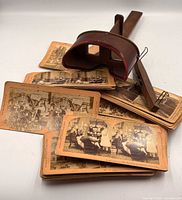 Stereoscope and stack of stereoview cards displayed together