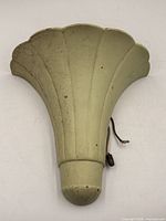 Front view of pale yellow metal fan-form sconce