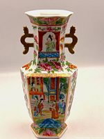 Front view showing hand-painted figural panel, floral borders, and gilt handles